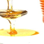 Honey getting poured on a spoon